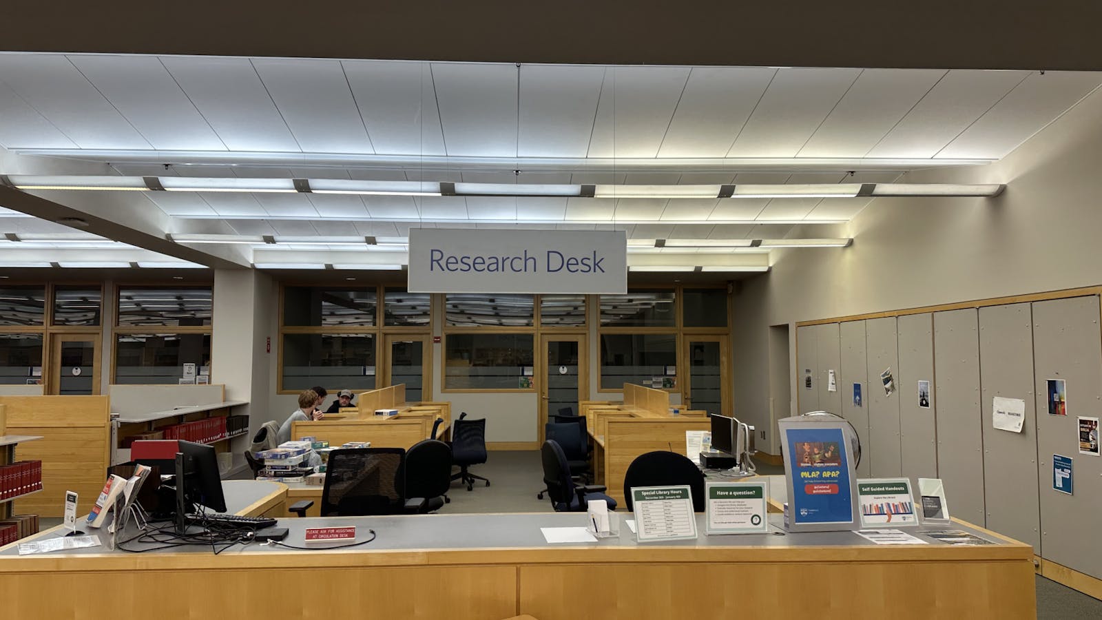 Library research desk with academic materials